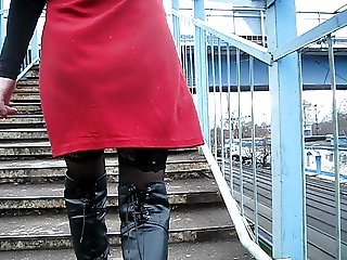 Girl in stockings and black leather boots going upstairs